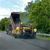 Construction vehicle on road torn up in residential neighborhood