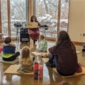 librarian reads to families