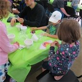 Children decorate a garden pot