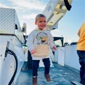 Child explores truck bed with cherry picker