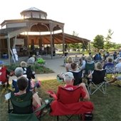 Audience listening to outdoor music at bandshell