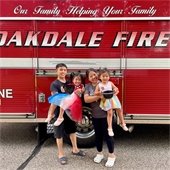 Family posing near fire truck