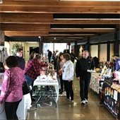 Shopper walks down aisle between vendor booths