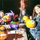 Kids holding pumpkins with stickers