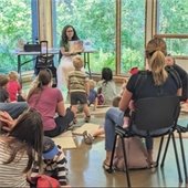 librarian reads to families