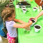 Child watering soil