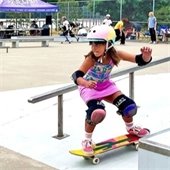 Child skateboarding with safety gear