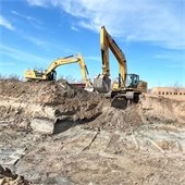 Construction vehicle on top of dirt pile